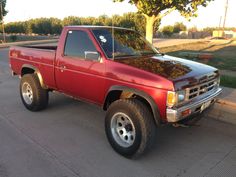 a red pick up truck parked on the street