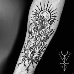 a black and white photo of a tattoo on the arm