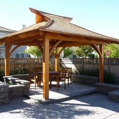 a wooden gazebo sitting on top of a stone patio