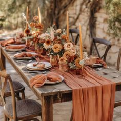 an outdoor table set with plates and place settings