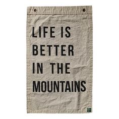 a tea towel that says life is better in the mountains