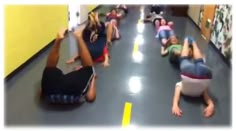 several people laying on the floor in a hallway