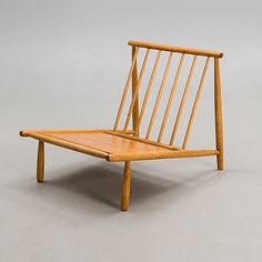 a wooden chair sitting on top of a white floor