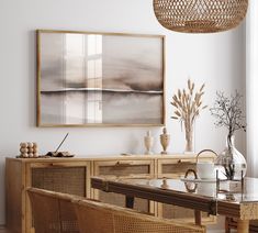 a dining room table with chairs and a painting on the wall above it, along with wicker furniture