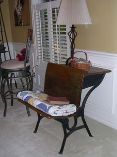 an old desk and chair are in the corner of this room with shuttered windows