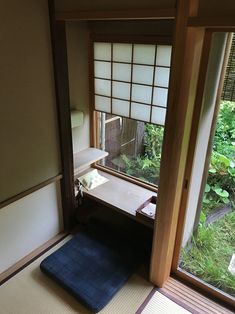 a room with an open window and tatami mat on the floor