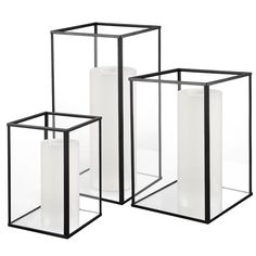 three black and white vases sitting next to each other