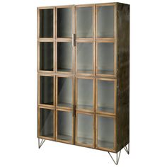 a wooden bookcase with glass doors and metal legs