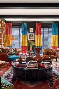 a living room filled with furniture and colorful curtains