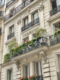 an apartment building with balconies and flower boxes on the balconies are shown