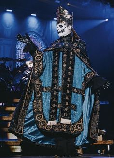 a man dressed in costume standing on stage