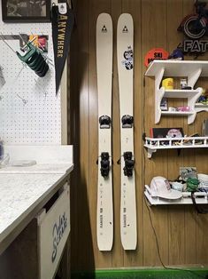 two skis are propped up against the wall