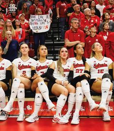 the women's basketball team is sitting on the bench