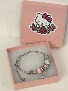 This charming Hello Kitty charm bracelet is a must-have for any fan of the beloved character. The bracelet features a round, silver metal charm with a dangle charm type and a pink color. It is customizable and can be sized to fit any wrist size. The bracelet is perfect for any occasion, whether it be for Mother's Day, Christmas, Graduation, Anniversary, Birthday, Christening, or Valentine's Day. It is a great addition to any jewelry collection and makes a fantastic gift for any Hello Kitty lover. The charm bracelet comes with a Pink Jewelry Box Get yours today! Hello Kitty Gifts For Gf, Hello Kitty Presents, Hello Kitty Gift Ideas, Bracelet Hello Kitty, Pink Charm Bracelet, Hello Kitty Charm, Kitty Anime, Pink Quince, Pink Jewelry Box