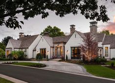 a large white house sitting on the side of a road