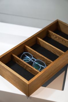 a pair of glasses in a wooden box