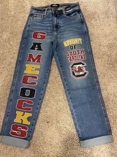 a pair of jeans with the words university of south carolina printed on them