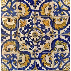 blue and yellow tile with an ornate design on the bottom, in different shapes and sizes