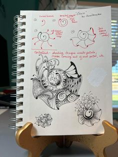 an open notebook with some drawings on it