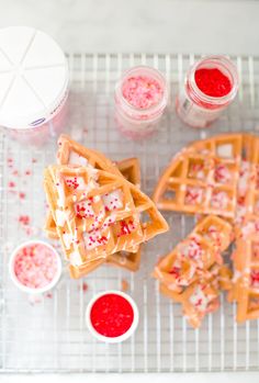 waffles with sprinkles on a cooling rack next to condiments