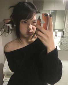 a woman taking a selfie in the bathroom