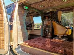 the interior of an rv with its door open and carpeted flooring on it