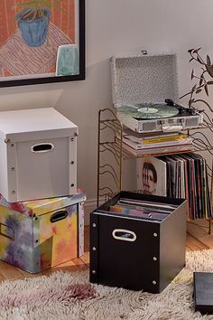 a room with various items on the floor, including boxes and record player's