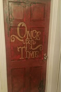 a red door with the words once upon time painted on it