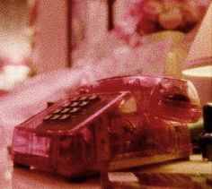 an old fashioned telephone sitting on top of a table