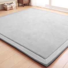 a large gray rug is on the floor