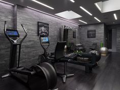 an exercise room with treadmills, machines and other equipment in it's center