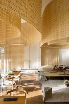 the inside of a restaurant with tables, chairs and benches in front of bamboo screens