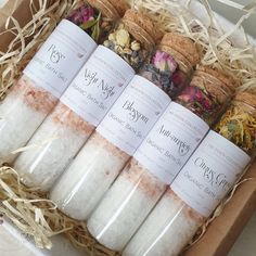 a box filled with lots of different types of bath salts in it's wrappers