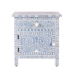 an ornate blue and white cabinet with drawers on the bottom, one drawer is open