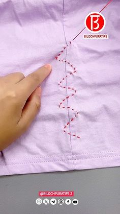 someone is stitching on the side of a pink shirt