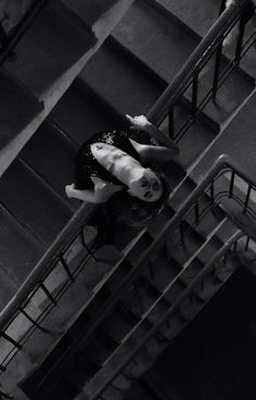 black and white photograph of woman on stairs