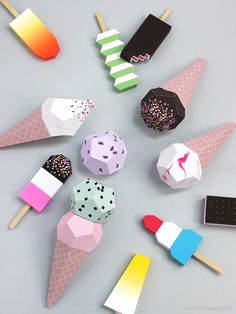 an assortment of ice cream cones with sprinkles on them and popsicles