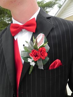 a man in a suit with a baseball and roses boutonniere on his lapel