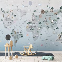 a child's room with a wall mural that has animals on it