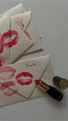 two envelopes that have lipstick on them