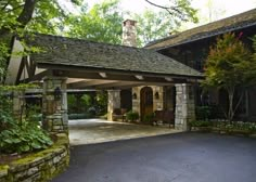 a large house with stone pillars and an attached patio