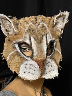 This unique cat mask are made of  hand painted burlap and eco-felt:  great for Halloween, masquerades and costume parties, photo shoots, and movie props. Perfect for props and group costumes. * Hand painted: waterproof acrylic inks * Lightweight and flexible: Eco felt and burlap  * Adjustable fit: cotton twill tape ties * Comfortable: lined with soft eco-felt * Free Shipping to most places This mask is in the U.S. Your order will ship within 3 days. Water resistant, but not water-proof. Cape, cl Halloween Cat Design Masks And Prosthetics For Costume Party, Halloween Cat Design Mask For Costume Party, Halloween Cat Ears Mask With Whiskers, Halloween Masquerade Masks With Whiskers, Crow Mask, Painted Burlap, Cat Masks, Painting Burlap, Cat Mask