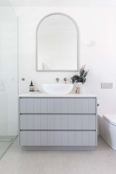 a bathroom with a sink, mirror and toilet