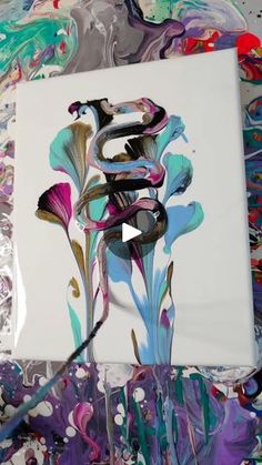 an artistic painting on canvas with paint splattered over it and the letter s