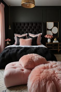 a bedroom with black walls, pink and white bedding and fur pom poms