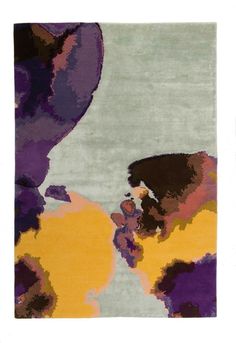 an area rug with various colors and shapes on it, including purples, yellows, and browns