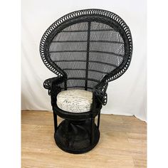 a black wicker chair with a white cushion