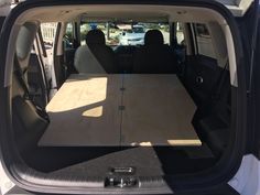 the back end of a van with a table in it