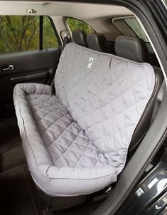 the interior of a car with an open hatchback and back seat cover on it