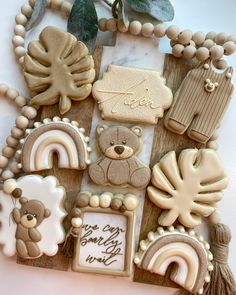 some cookies are arranged on a table with leaves and beads around them that say happy new year